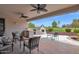 A covered patio featuring comfortable seating and an outdoor BBQ overlooking the lush golf course at 17443 N Goldwater Dr, Surprise, AZ 85374