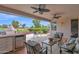 Covered patio with built in BBQ, comfortable seating, and view to golf course at 17443 N Goldwater Dr, Surprise, AZ 85374