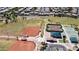 Aerial view of a community park, baseball field, tennis courts and green space offer recreational opportunities at 19072 N Ventana Ln, Maricopa, AZ 85138