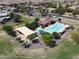 Aerial view showcasing a community pool, splash pad, shaded lounge chairs and community landscaping at 19072 N Ventana Ln, Maricopa, AZ 85138
