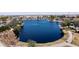 Aerial view of community lake with walking path, mature trees, and lush landscaping creating a great community area at 19072 N Ventana Ln, Maricopa, AZ 85138