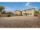 Expansive backyard featuring low-maintenance desert landscaping with a brick fire pit area, perfect for relaxing outdoors at 19072 N Ventana Ln, Maricopa, AZ 85138