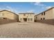 Large backyard with desert landscaping and brick patio area featuring a central fire pit for outdoor enjoyment at 19072 N Ventana Ln, Maricopa, AZ 85138