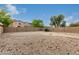 Large backyard with desert landscaping and brick patio area featuring a central fire pit for outdoor enjoyment at 19072 N Ventana Ln, Maricopa, AZ 85138
