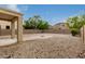 Spacious backyard featuring stone landscaping, brick fire pit area, and covered patio, great for outdoor entertaining at 19072 N Ventana Ln, Maricopa, AZ 85138