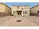 Backyard with low-maintenance desert landscaping, brick patio, and fire pit, perfect for outdoor living and entertaining at 19072 N Ventana Ln, Maricopa, AZ 85138