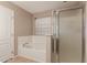 Bathroom with a shower and a separate soaking tub at 19072 N Ventana Ln, Maricopa, AZ 85138