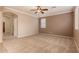 Neutral toned main bedroom with plush carpet, and access to the living areas at 19072 N Ventana Ln, Maricopa, AZ 85138