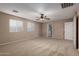 Large carpeted bedroom featuring neutral walls, two windows, and interior doors at 19072 N Ventana Ln, Maricopa, AZ 85138