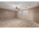 Spacious carpeted bedroom featuring neutral walls, two windows, and a ceiling fan at 19072 N Ventana Ln, Maricopa, AZ 85138