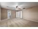 Large carpeted bedroom featuring neutral walls and large open doorways at 19072 N Ventana Ln, Maricopa, AZ 85138