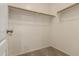 A walk-in closet with wooden racks for storage at 19072 N Ventana Ln, Maricopa, AZ 85138