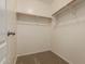 A walk-in closet featuring wooden racks for storage and organization at 19072 N Ventana Ln, Maricopa, AZ 85138