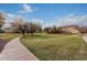 Lush green community park with walking paths and mature trees, offering a serene and inviting atmosphere at 19072 N Ventana Ln, Maricopa, AZ 85138