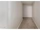 Neutral-toned hallway with carpet that provides access to different rooms and areas of the house at 19072 N Ventana Ln, Maricopa, AZ 85138