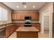 Bright kitchen with stainless appliances, light wood cabinets, and center island at 19072 N Ventana Ln, Maricopa, AZ 85138