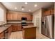 Bright kitchen with stainless appliances, light wood cabinets, and center island at 19072 N Ventana Ln, Maricopa, AZ 85138