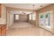 Open floor plan with a spacious living room adjacent to the kitchen featuring lots of natural light at 19072 N Ventana Ln, Maricopa, AZ 85138