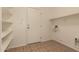 Pantry has tiled floor, storage shelves, and a door to the outside at 19072 N Ventana Ln, Maricopa, AZ 85138