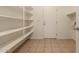 Spacious pantry featuring floor tiling and ample shelving storage space at 19072 N Ventana Ln, Maricopa, AZ 85138