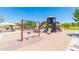 Vibrant playground with swings, slides and climbing features set in a sandy play area at 19072 N Ventana Ln, Maricopa, AZ 85138