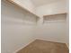 Carpeted walk-in closet with shelving at 19072 N Ventana Ln, Maricopa, AZ 85138