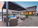 Spacious backyard featuring a pool, lounge area, dining, and manicured landscaping at 19443 W Valle Vista Way, Litchfield Park, AZ 85340