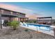 A beautiful backyard features a pool, outdoor seating, and well manicured landscaping, all enclosed for privacy at 19443 W Valle Vista Way, Litchfield Park, AZ 85340