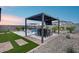 Landscaped backyard with pergola, outdoor seating and dining, and a sparkling pool at 19443 W Valle Vista Way, Litchfield Park, AZ 85340