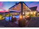 Outdoor haven with a sparkling pool, a cozy fire pit lounge area, an outdoor kitchen, and a built in bar top at 19443 W Valle Vista Way, Litchfield Park, AZ 85340