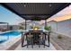 Outdoor seating area with a fire pit table perfect for socializing next to in ground pool at 19443 W Valle Vista Way, Litchfield Park, AZ 85340