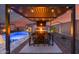 Backyard paradise with a firepit table, a bar top with seating, a shimmering pool and a modern pergola at 19443 W Valle Vista Way, Litchfield Park, AZ 85340