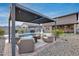 Serene backyard featuring a sparkling pool, comfortable seating area, and lush landscaping at 19443 W Valle Vista Way, Litchfield Park, AZ 85340