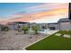 A beautiful backyard features a pool, outdoor seating, and well manicured landscaping, all enclosed for privacy at 19443 W Valle Vista Way, Litchfield Park, AZ 85340