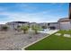 Spacious backyard oasis featuring a sparkling pool, stylish pergolas, and lush landscaping at 19443 W Valle Vista Way, Litchfield Park, AZ 85340