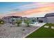 Expansive backyard with pool, entertainment areas, and lush landscaping at 19443 W Valle Vista Way, Litchfield Park, AZ 85340