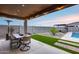 Outdoor living is easy in this yard with a patio table and chairs, artificial turf, and built in barbeque at 19443 W Valle Vista Way, Litchfield Park, AZ 85340