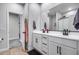 Bright bathroom featuring double vanity, sleek black fixtures, and a glimpse of a spacious shower at 19443 W Valle Vista Way, Litchfield Park, AZ 85340