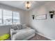 Bright bedroom with a comfortable couch, natural light from the window, and stylish decor at 19443 W Valle Vista Way, Litchfield Park, AZ 85340