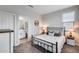 Bright bedroom featuring a bed, windows, and view to the ensuite bathroom at 19443 W Valle Vista Way, Litchfield Park, AZ 85340