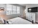 Bright bedroom with a window, television, and a closet at 19443 W Valle Vista Way, Litchfield Park, AZ 85340