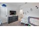 bedroom with a dinosaur theme, a television, closet, and comfortable gray carpet at 19443 W Valle Vista Way, Litchfield Park, AZ 85340