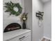 Charming entryway featuring white shiplap paneling, a decorative wreath, and stylish home decor accents at 19443 W Valle Vista Way, Litchfield Park, AZ 85340