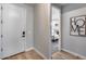 Light and airy entryway showcases wood floors, with a glimpse into a guest bedroom at 19443 W Valle Vista Way, Litchfield Park, AZ 85340