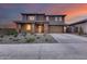 Charming two-story home featuring a two-car garage, stone accents and desert landscaping at 19443 W Valle Vista Way, Litchfield Park, AZ 85340