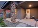 View of front porch area with stone columns and stylish decorations, including a 