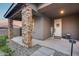 Inviting porch area with attractive stone columns and a welcoming front entrance with a decorative sign at 19443 W Valle Vista Way, Litchfield Park, AZ 85340