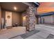 Inviting front porch featuring stone columns, and stylish décor at 19443 W Valle Vista Way, Litchfield Park, AZ 85340