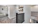 Hallway view with decorative shelves and black metal railing, carpet, and view to the next room at 19443 W Valle Vista Way, Litchfield Park, AZ 85340