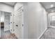 Hallway featuring neutral colored carpet, white walls, and bright lighting, and storage cabinets at 19443 W Valle Vista Way, Litchfield Park, AZ 85340
